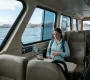 A traveler sitting inside a Galapagos ferry cabin during a boat trip between islands, showing the interior and ocean view.