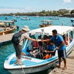 Gal谩pagos Water Taxi Fee 2026-2027: Pier Rates Guide A tourist handing payment to a water taxi driver at a wooden pier in the Galapagos Islands.